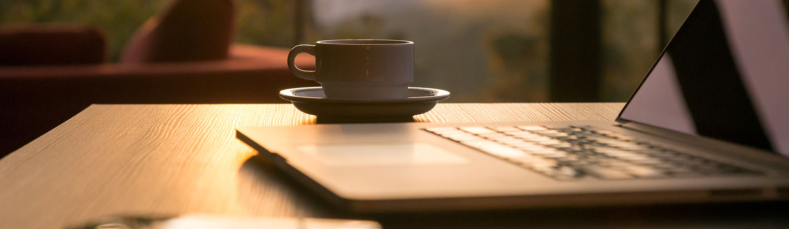 a laptop and coffee cup on a table