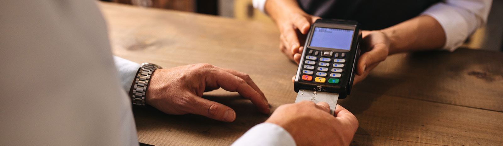 close up of a person's hands using a credit card